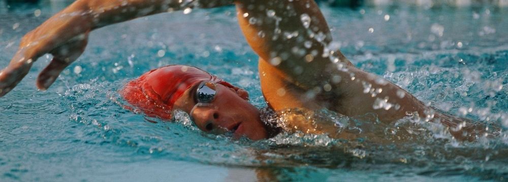 Man swims laps for healthy exercise that works with his hip, knee, and back pain as recommended by the team at Premier Orthopaedics and Trauma Specialists 